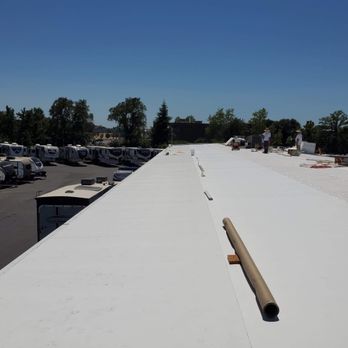 DC Roofing & Waterproofing Systems - Industrial corrugated metal building and roof. Applying 60 mil PVC Membrane over flute filler insulation and densdek. - Roofing Near Me - Rocklin, California