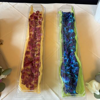 Cupertino Florist - Double orchid leis in purple/yellow and blue. The blue lei color did bleed a little bit, but we still displayed it on the table - Florists Near Me - San Jose, California Cupertino Florist - Double orchid leis in purple/yellow and blue. The blue lei color did bleed a little bit, but we still displayed it on the table - Florists Near Me - San Jose, California
