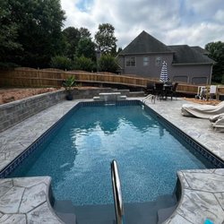 Merodynamic Pools - In ground vinyl liner pool with stamped, colored and sealed concrete, sheer descent waterfall and a diamond pro retaining wall.