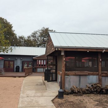Black's BBQ - Coming in from parking lot, smokehouse on right - Barbeque Near Me - San Marcos, Texas