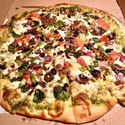 Veggie pizza with pesto sauce and I added sausage. Veggie pizza with pesto sauce and I added sausage.