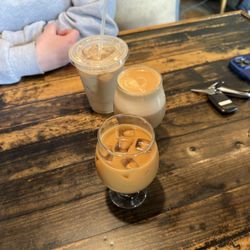 Forward Craft & Coffee - From back to front, caramel iced latte 16oz, Fowpaw flavored flat white, sweet and creamy cold brew 8oz