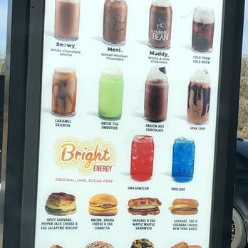 The Human Bean - A vertical menu board displays coffee beverages, energy drinks, and food options at The Human Bean, including specialty drinks and snacks. - Coffee & Tea Near Me - Los Lunas, New Mexico