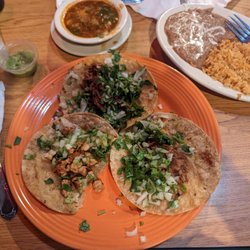 Cuernavaca Grill Mexican Restaurant - Chicken and birria tacos, refried beans and rice. I used the "soup" as a topping for my tacos.
