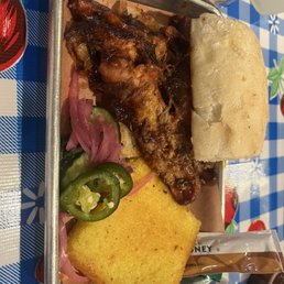 Barbecue pulled pork sandwich with a side of cornbread. Barbecue pulled pork sandwich with a side of cornbread.