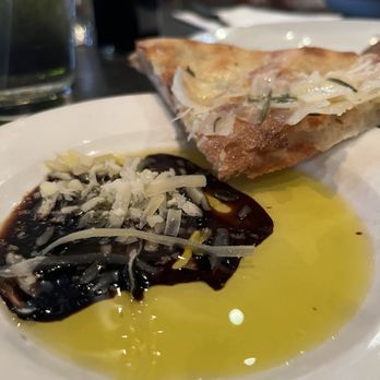 PINO - Wedge of foccacia and plate of olive oil, balsamic, and shredded Parmesan - Italian Near Me - Phoenix, Arizona