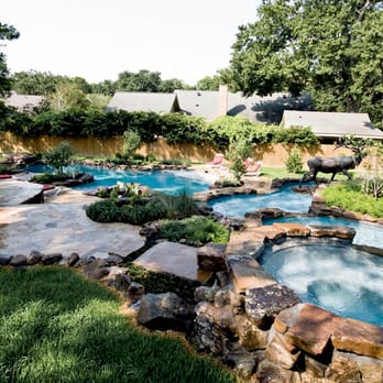 Ewing Aquatech Pools, Inc - a view of a backyard pool - General Contractors Near Me - Baton Rouge, Louisiana