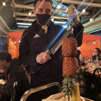 Rainhas Churrascaria - Johny serving caramelized pineapple, soo good!! - Brazilian Near Me - Corona, New York Rainhas Churrascaria - Johny serving caramelized pineapple, soo good!! - Brazilian Near Me - Corona, New York