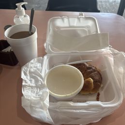 Sausage Eggs and Cheese on croissant. Grits and coffee. Sausage Eggs and Cheese on croissant. Grits and coffee.