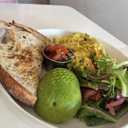 Organic turmeric tofu scramble with sautéed veggies and avocado Organic turmeric tofu scramble with sautéed veggies and avocado
