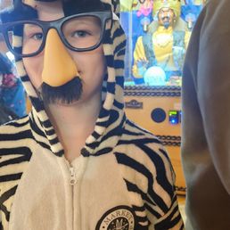 My son in a zebra costume and disguise glasses in front of market magic shop's "Zoltar" fortune teller machine. My son in a zebra costume and disguise glasses in front of market magic shop's "Zoltar" fortune teller machine.