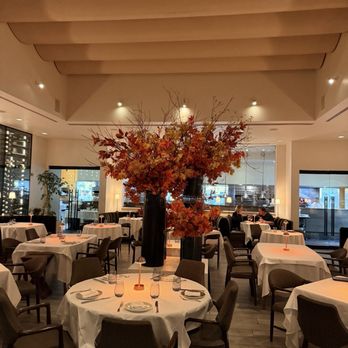 Spago - Festive with fall flowers; Spago indoor dining area. - New American Near Me - Beverly Hills, California