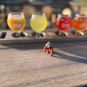 Local Roots Kombucha - a miniature figurine of a man holding a glass of kombucha - Kombucha Near Me - Vista, California