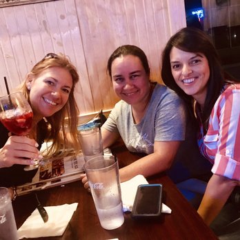 Route 65 - three women sitting at a table with drinks - Beer Bar Near Me - Orlando, Florida Route 65 - three women sitting at a table with drinks - Beer Bar Near Me - Orlando, Florida