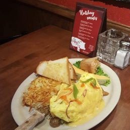 Wild alligator sausage with a mixture of green, red, and orange bell peppers with Hollandaise sauce, toast, hash browns, and a tiny muffin. Wild alligator sausage with a mixture of green, red, and orange bell peppers with Hollandaise sauce, toast, hash browns, and a tiny muffin.