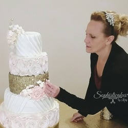 Sophisticakes By Mary - Mary, owner and operator of Sophisticakes By Mary, putting the finishing touches on a wedding cake.