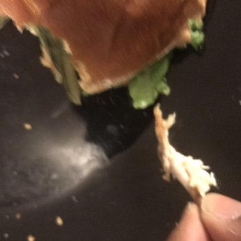 McDonalds - a hand holding a half eaten sandwich - Fast Food Near Me - Romeoville, Illinois