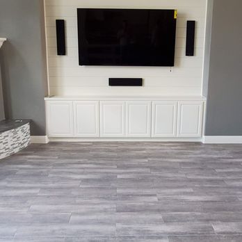 Silent Summit Home Services - Custom built-in entertainment center featuring base cabinets and a shiplap feature wall, with all media components neatly concealed inside - Handyman Near Me - Bozeman, Montana Silent Summit Home Services - Custom built-in entertainment center featuring base cabinets and a shiplap feature wall, with all media components neatly concealed inside - Handyman Near Me - Bozeman, Montana