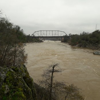 Historic Truss Bridge - view of Truss bridge during heavy rain in 2017 from up the river - Landmarks & Historical Buildings Near Me - Folsom, California Historic Truss Bridge - view of Truss bridge during heavy rain in 2017 from up the river - Landmarks & Historical Buildings Near Me - Folsom, California
