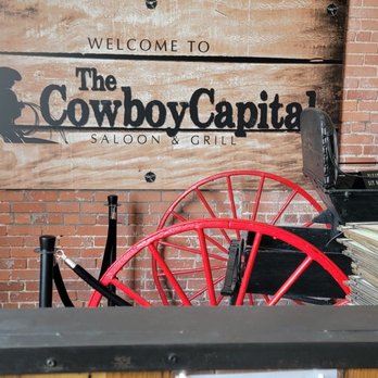Cowboy Capital Grille - a bar with red chairs - American Near Me - Dodge City, Kansas