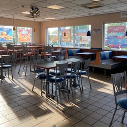 a restaurant with tables and chairs a restaurant with tables and chairs