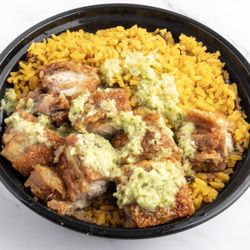 Caribe Spanish Restaurant and Sports Bar - Chicharron with garlic sauce over yellow rice