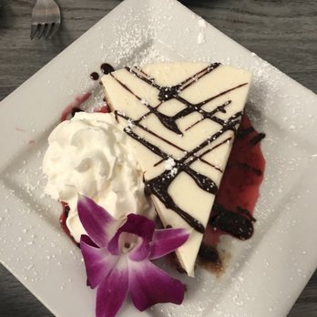 Victor's - Vanilla mouse on flourless chocolate cake with raspberry sauce - New American Near Me - Provincetown, Massachusetts Victor's - Vanilla mouse on flourless chocolate cake with raspberry sauce - New American Near Me - Provincetown, Massachusetts