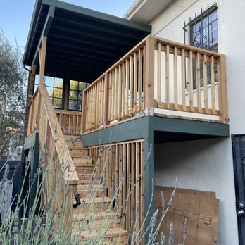 Bay Modern Build Inc - Second-story deck with an overhead roof and windows, built from Western Red Cedar. - General Contractors Near Me