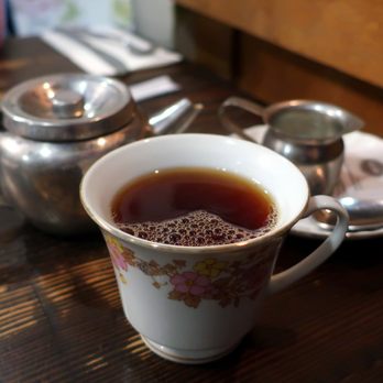 Chartier - a cup of tea on a table - French Near Me - Beaumont, Alberta