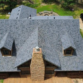 Don Roofing & Siding - Aerial view of a log cabin roof replacement in Branson, MO with gray shingles. - Roofing Near Me - Branson, Missouri Don Roofing & Siding - Aerial view of a log cabin roof replacement in Branson, MO with gray shingles. - Roofing Near Me - Branson, Missouri