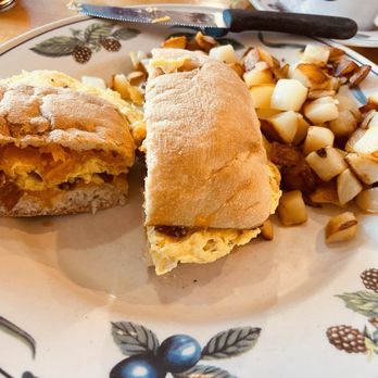 Egg'lectic Cafe - breakfast sandwich with greasy uncooked cubed potatoes - Breakfast & Brunch Near Me - Wheaton, Illinois