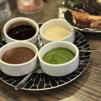 Drift - Sauces for the tomahawk steak- chimichurri sauce, cognac peppercorn, horseradish and red wine Bordeaux sauce - New American Near Me - Weehawken, New Jersey