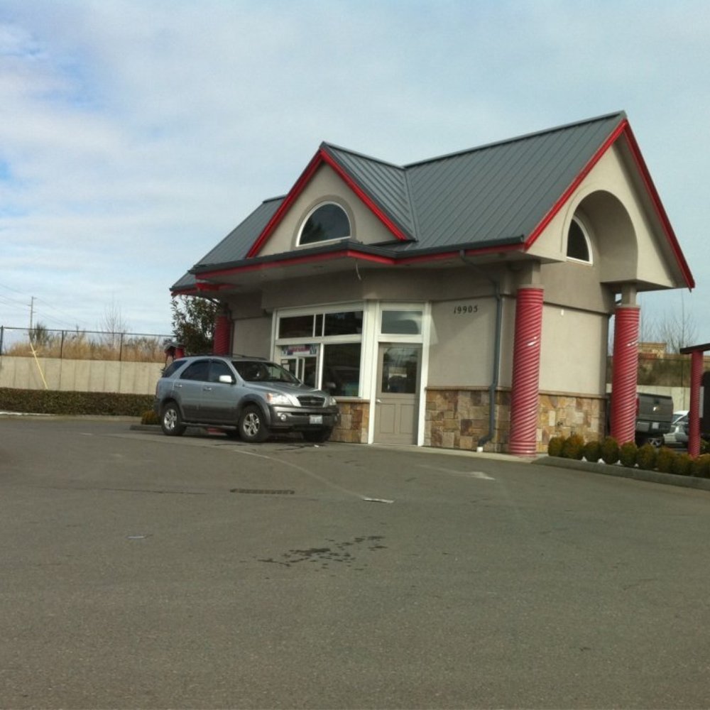 a car parked in front of a fast food restaurant a car parked in front of a fast food restaurant
