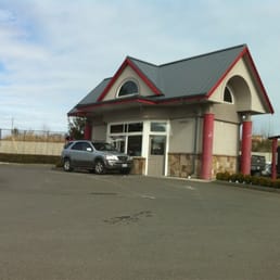 a car parked in front of a fast food restaurant a car parked in front of a fast food restaurant