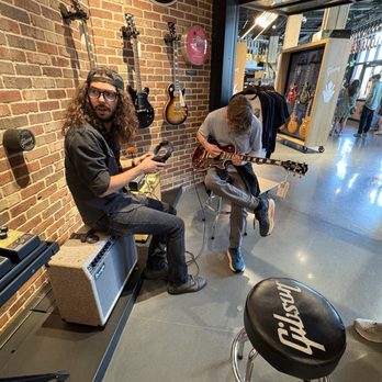 The Gibson Garage - Gibson store trying out a guitar. - Guitar Stores Near Me - Nashville, Tennessee The Gibson Garage - Gibson store trying out a guitar. - Guitar Stores Near Me - Nashville, Tennessee