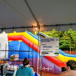 Another vendor selling sweets and bouncy bouncy in the back.