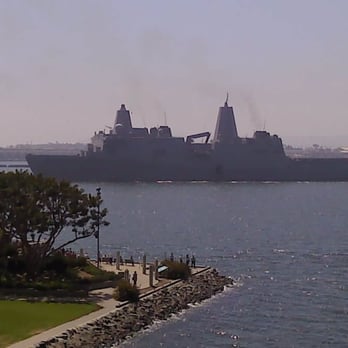 Embracing Peace - As they kiss away the USS New Orleans in background sets out to sea - Landmarks & Historical Buildings Near Me - San Diego, California