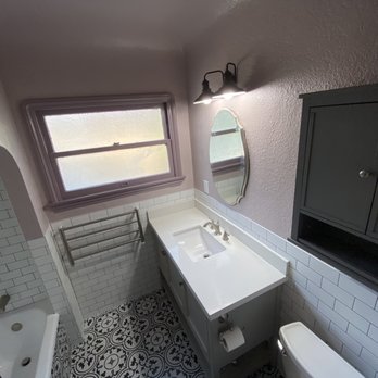 KM Home Design - Floor tile, subway tile on walls. New towel warmer on wall below window, new vanity, cupboard and mirror and light fixture. - General Contractors Near Me - Los Angeles, California KM Home Design - Floor tile, subway tile on walls. New towel warmer on wall below window, new vanity, cupboard and mirror and light fixture. - General Contractors Near Me - Los Angeles, California