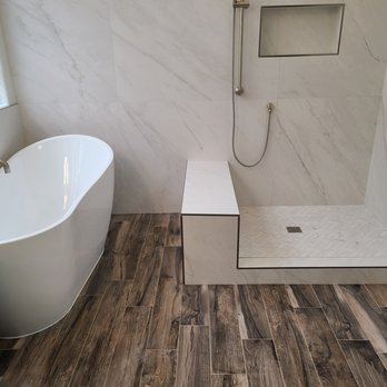Champion Remodel - a bathtub and shower in a bathroom - General Contractors Near Me Champion Remodel - a bathtub and shower in a bathroom - General Contractors Near Me