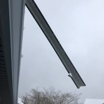 Cornerstone Construction - One of the snow rails that was incorrectly installed-you can see it was only screwed to the roof on the bottom instead of both bottom & top. - Roofing Near Me - Travelers Rest, South Carolina