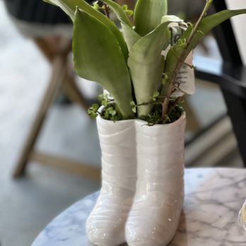 The Roasted Record - a pair of white boots with plants in them - Vinyl Records Near Me - Stuart, Florida