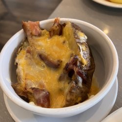 Mo's Fisherman's Wharf Inner Harbor - Baked potato slathered with cheese and strips of bacon