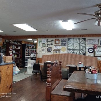 Ruckel's Restaurant - the inside of the restaurant - Inside Ruckel's Restaurant, featuring wooden paneling, wall art, a large clock, and ceiling fans, with seating and a view of the menu board. - Southern Near Me - Eubank, Kentucky