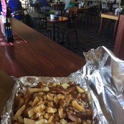 Le Montreal Shack - Poutine with view of bar. I had to get takeaway but you should eat in.