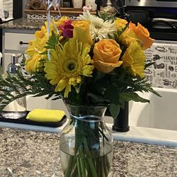 A Crooked Stem Flowers & Gifts - The happy daisy is mostly cheap yellow daisies and orange roses????