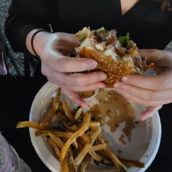 Diego's Food Truck - a woman eating a hamburger and french fries - Tacos Near Me - McAllen, Texas Diego's Food Truck - a woman eating a hamburger and french fries - Tacos Near Me - McAllen, Texas