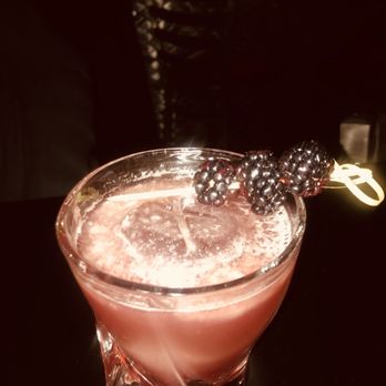 X Bar - a drink with a blackberry garnish garnish - Cocktail Bars Near Me - Flint, Michigan