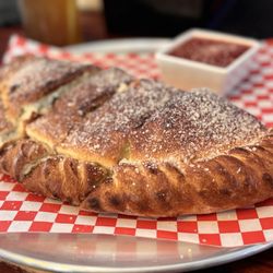 Lava Louie's - HUGE Calzone sitting on a 12" pizza platter!