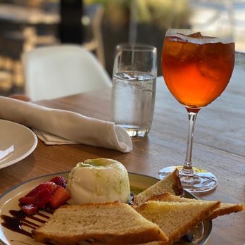 Fiore Famiglia - a plate of food and a glass of wine - Italian Near Me - Vancouver, British Columbia