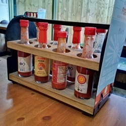 Perios - Bottles of sauces on every table